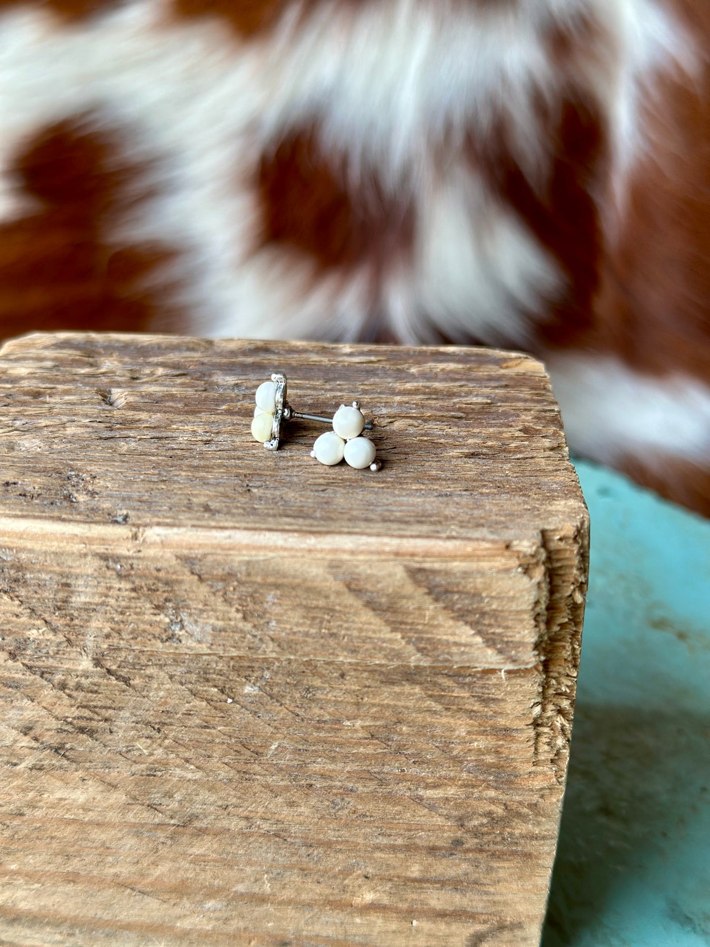 Pair of Laura White Turquoise Stud Earrings with a round faux white turquoise stone set, perfect for adding a pop of neutral color to any outfit.