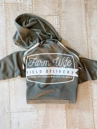 Close-up of the Lawrence Farm Wife Field Delivery Hoodie, highlighting the olive green fabric and ivory lettering