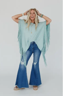 Model showcasing Lippy Fringe Top in washed seafoam with boat neckline and exaggerated short sleeves.