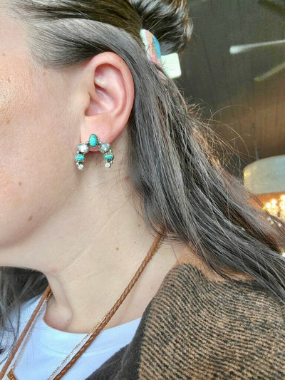 Heirloom-Quality Sterling Silver Earrings with Authentic Turquoise shown on a model for size relevance.