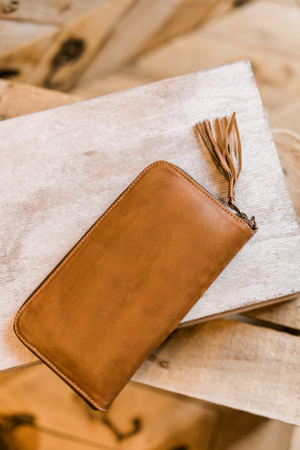 Western-style leather wristlet in natural tone with unique hand-dyed variations.