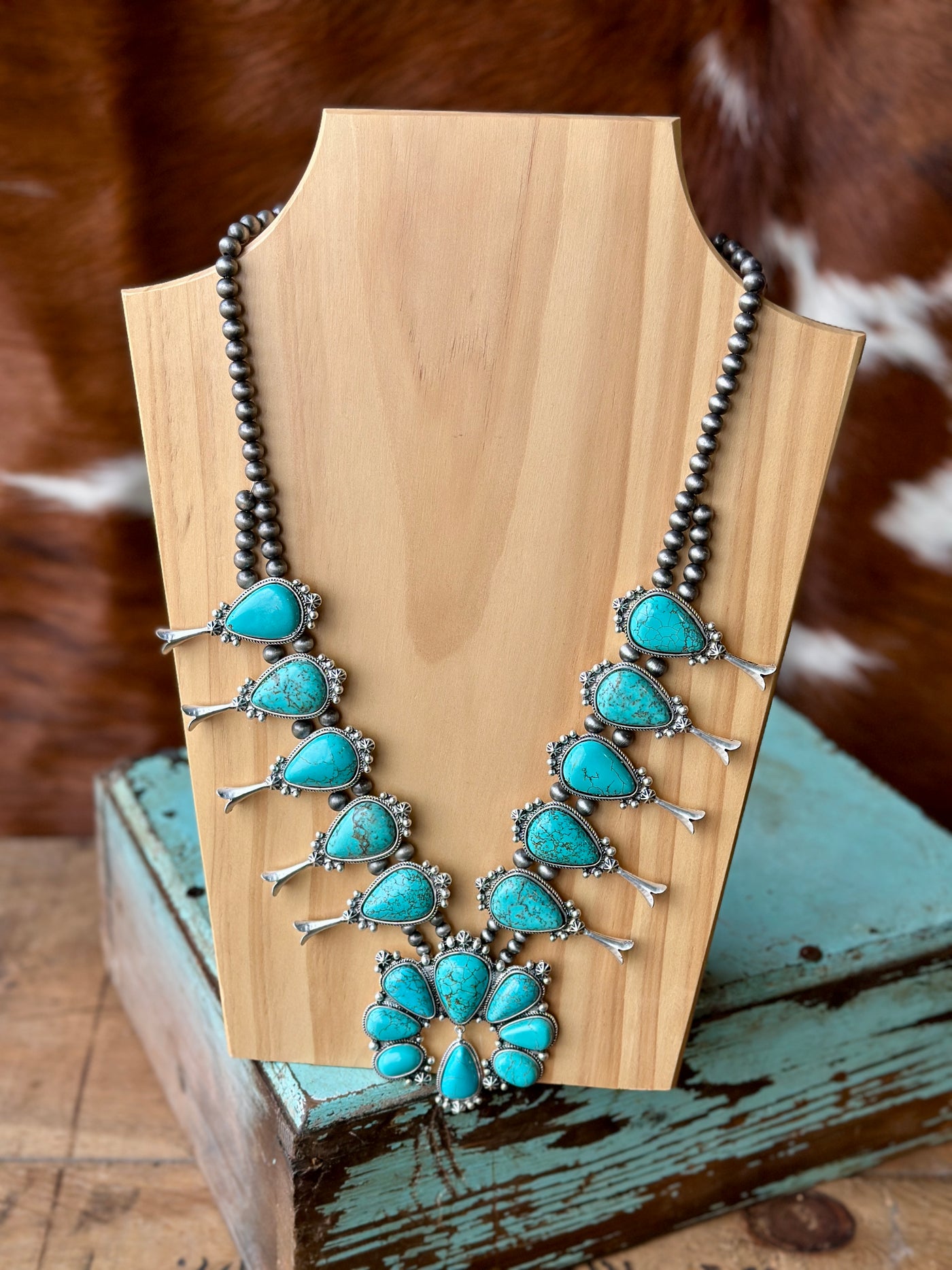 Marty Turquoise Squash Blossom Necklace with faux turquoise stones and iconic silver-tone squash blossom design.