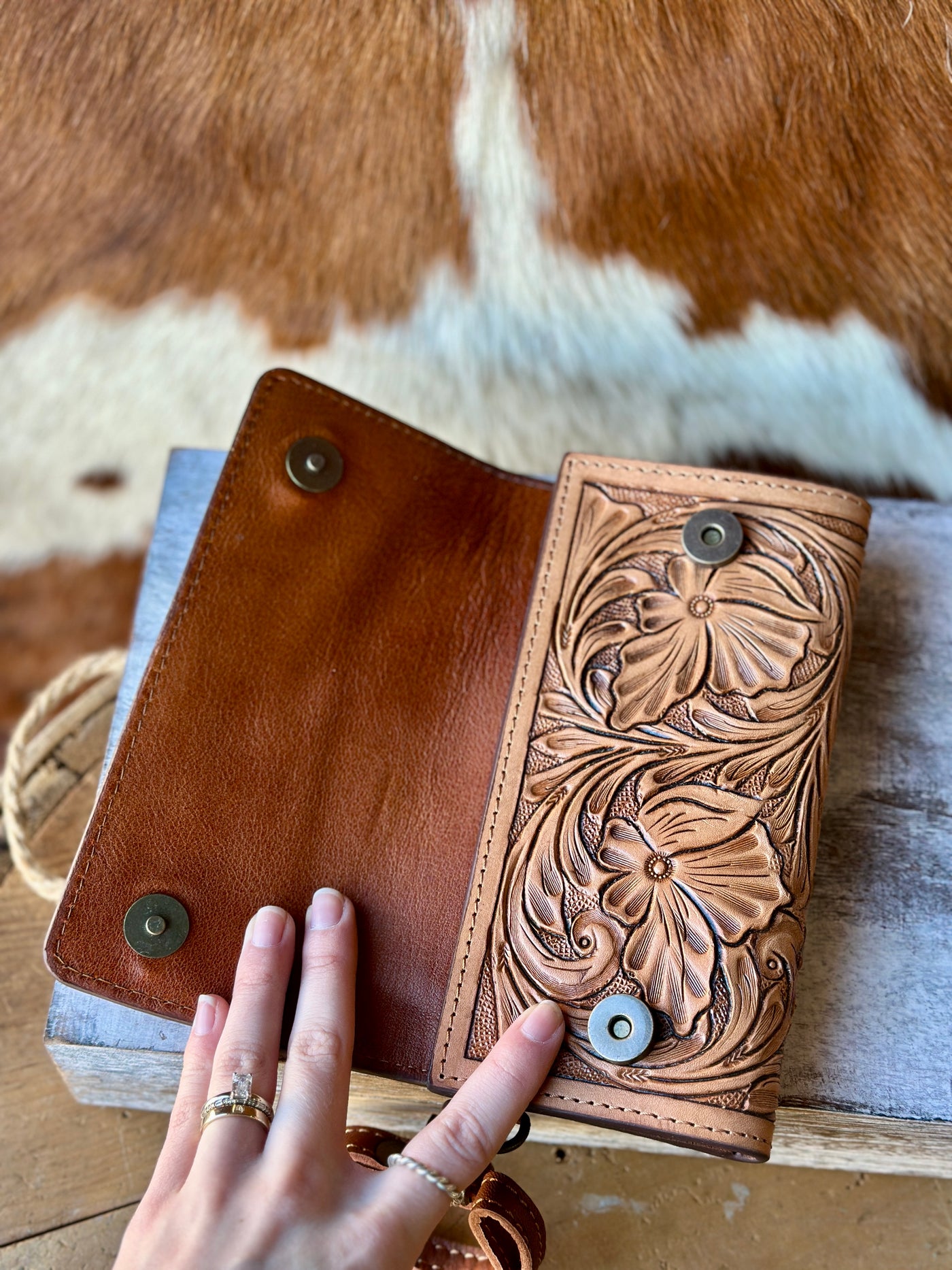 Detailed Close-Up of Hand-Tooled Leather Design and the snap closure of the Matilda Clutch.