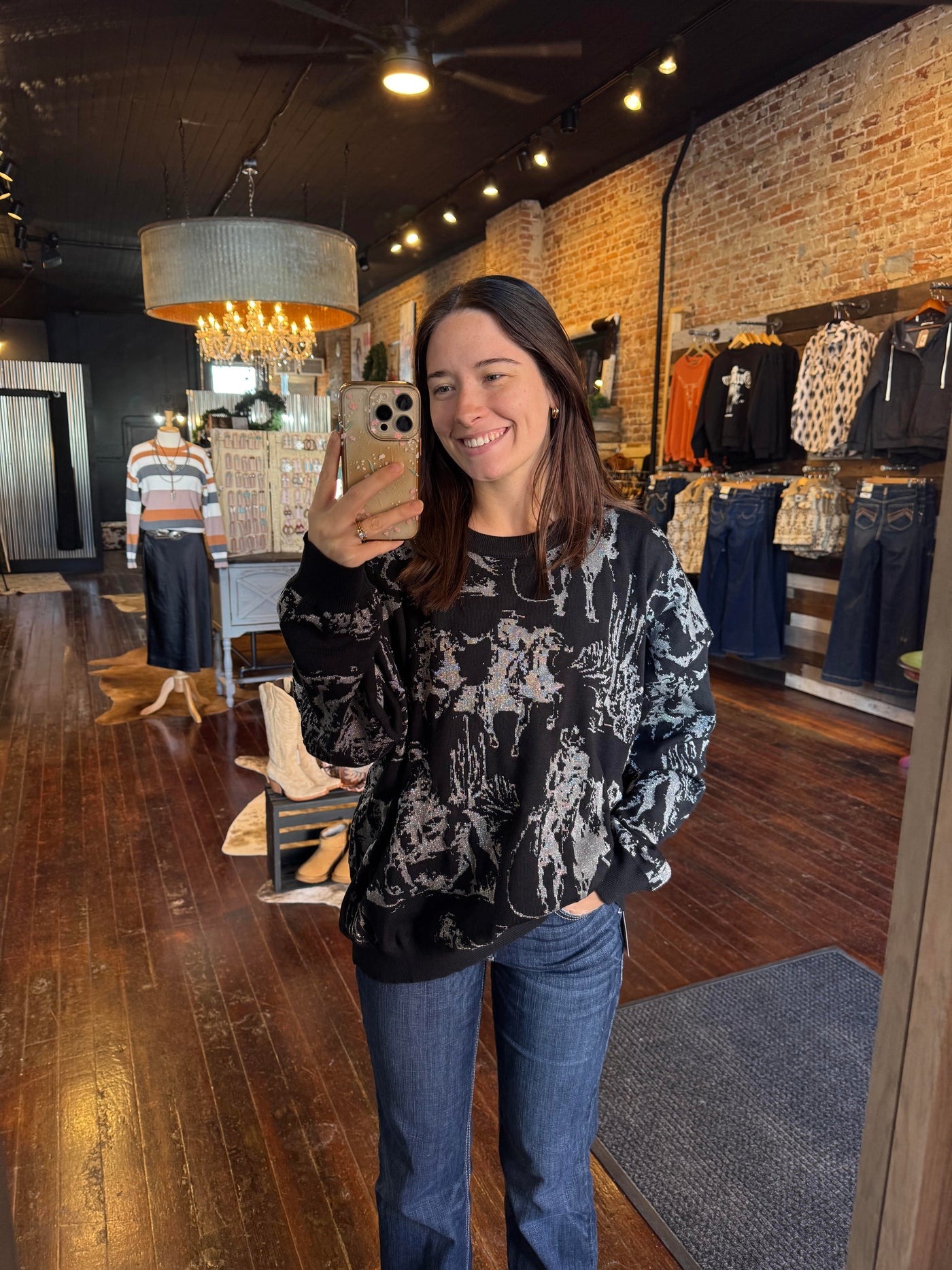 Reversible Mayfield Metallic Knit Sweater showcasing the bold black design on metallic silver background as shown by Broker Leather employee model.