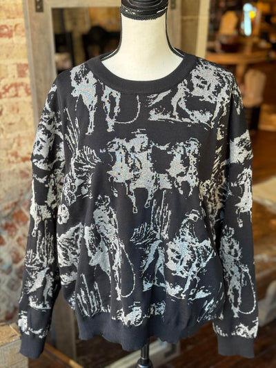 Close-up of Mayfield Metallic Knit Sweater showing the intricate cowboy and horse roping scene.