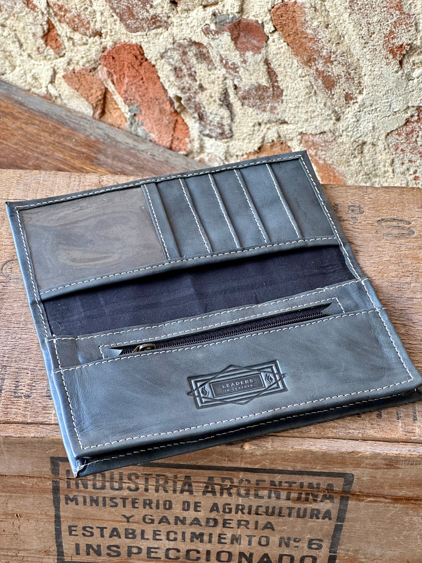 Detail shot of the zippered coin pouch in the McCrae Wallet for secure storage of loose change.