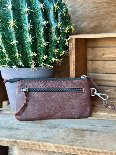 Western cowgirl coin purse wristlet with handcrafted tooled leather and secure zipper closure.