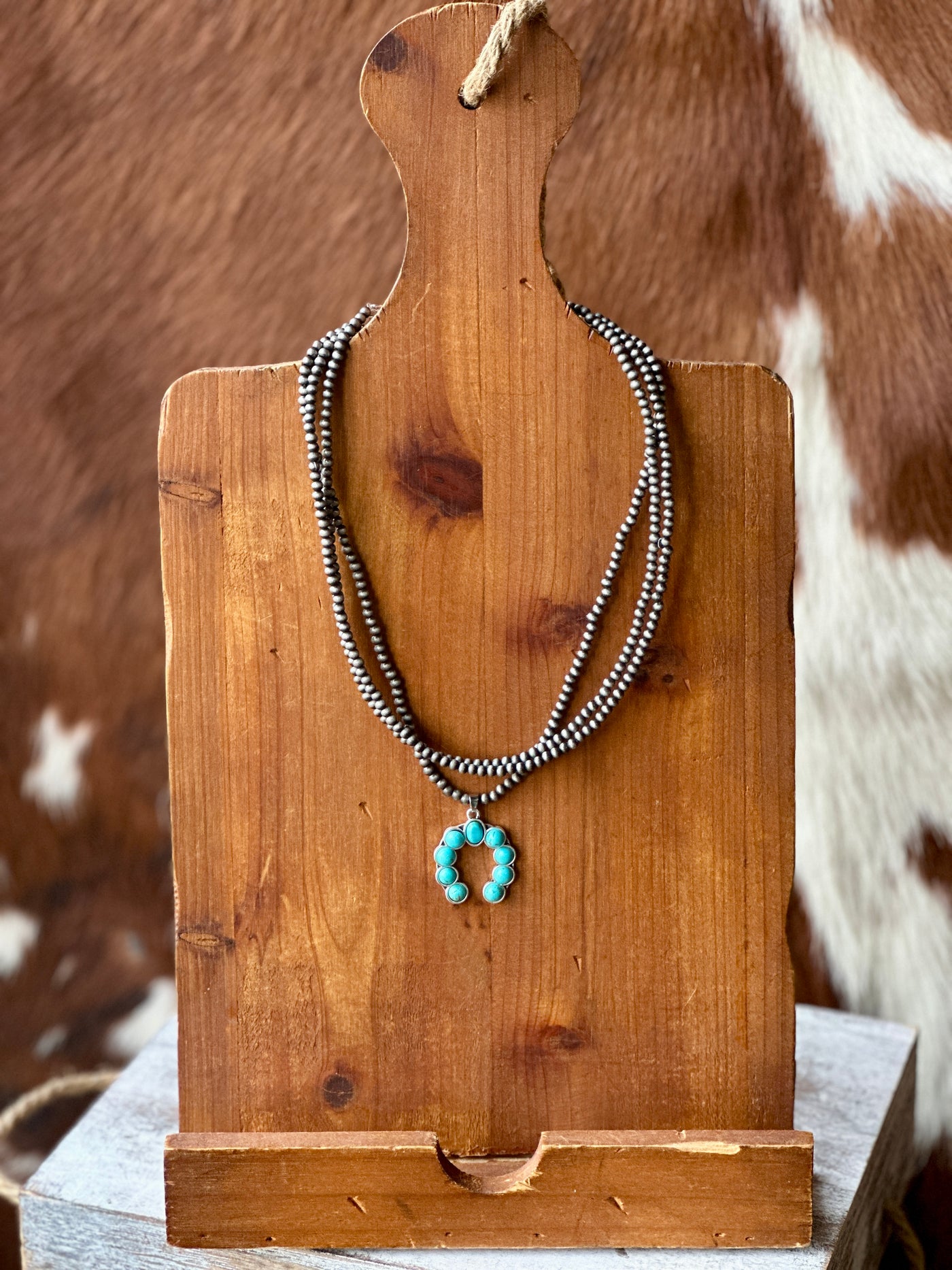 Mia Squash Turquoise Necklace – three-strand Western necklace with a faux turquoise squash blossom pendant.