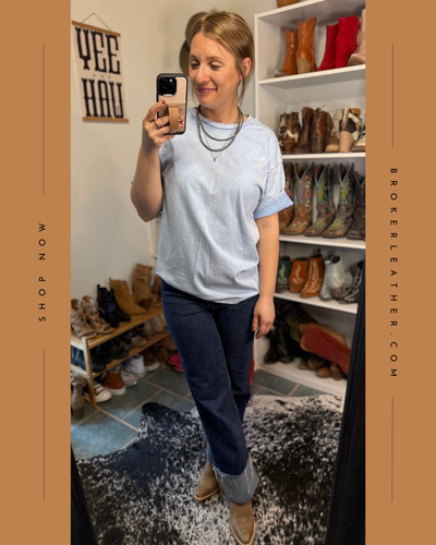 Western-inspired blue t-shirt styled with distressed denim and boots