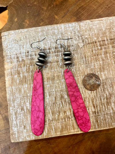 Detailed view of Mike Pink Slab Earrings with vibrant pink hues and distinctive stone-like patterns next to a penny for size comparison. 