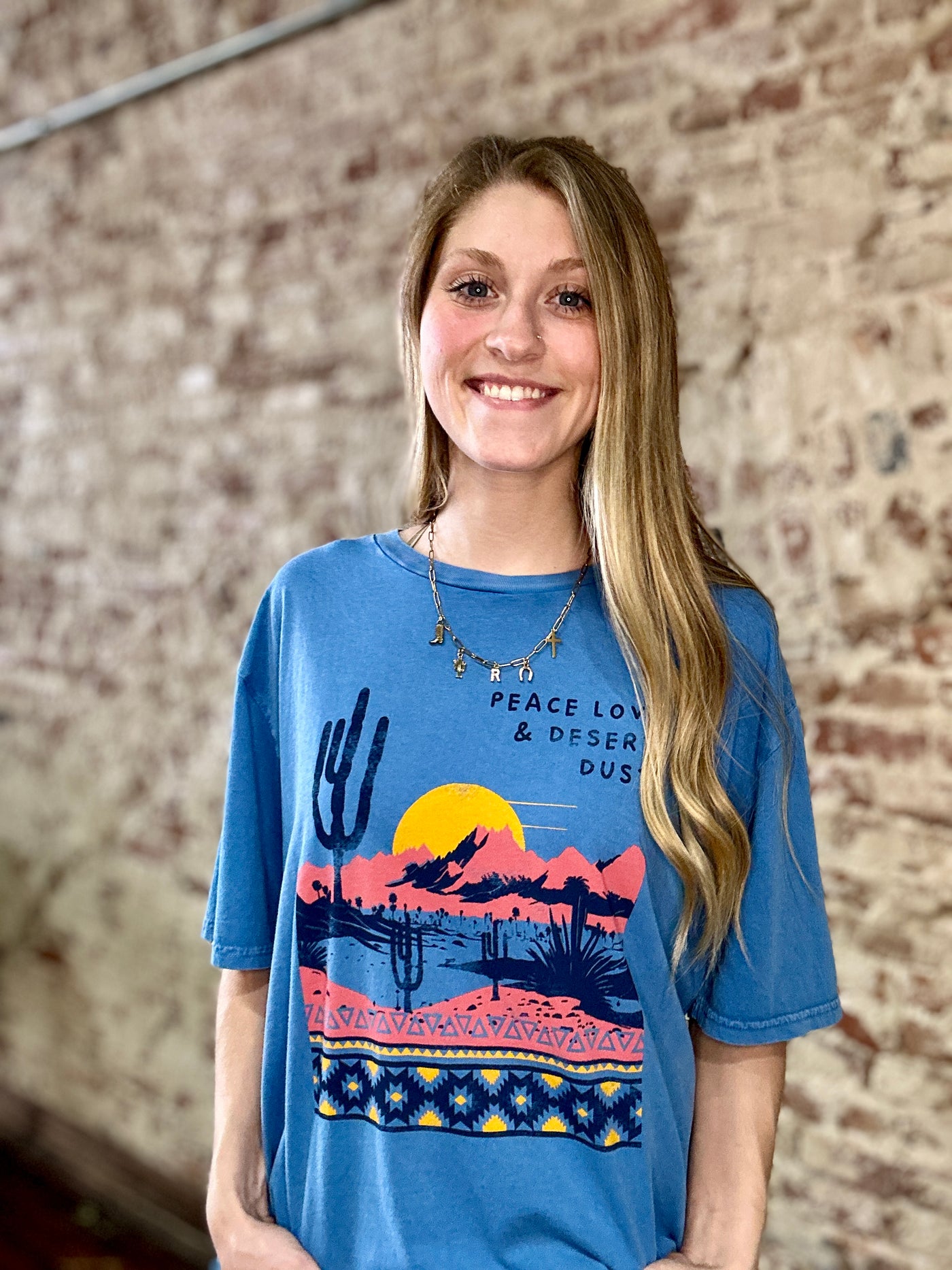 A Broker Leather employee modeling the Moab Desert Dust Graphic Tee available in-store and online now.