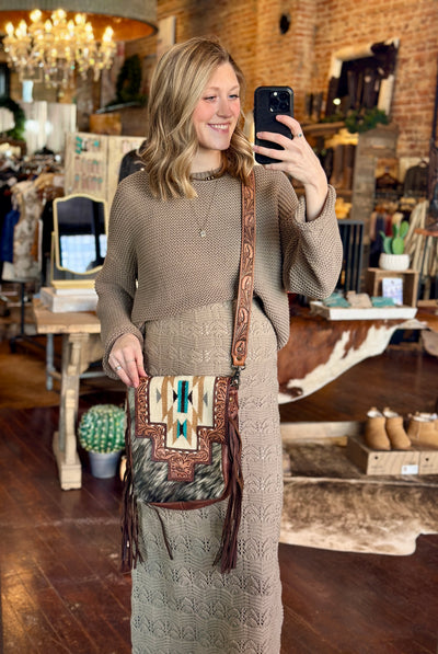 Western-Style Leather Fringe Purse with Southwestern Color Accents modeled by Broker Leather employee to show size relevance.