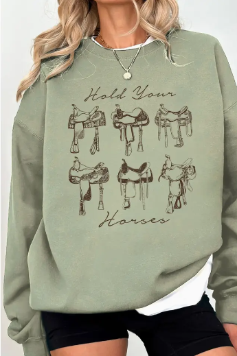 Nelly Hold Your Horses Crewneck sweatshirt with sage green base and bold chocolate brown saddle graphic.