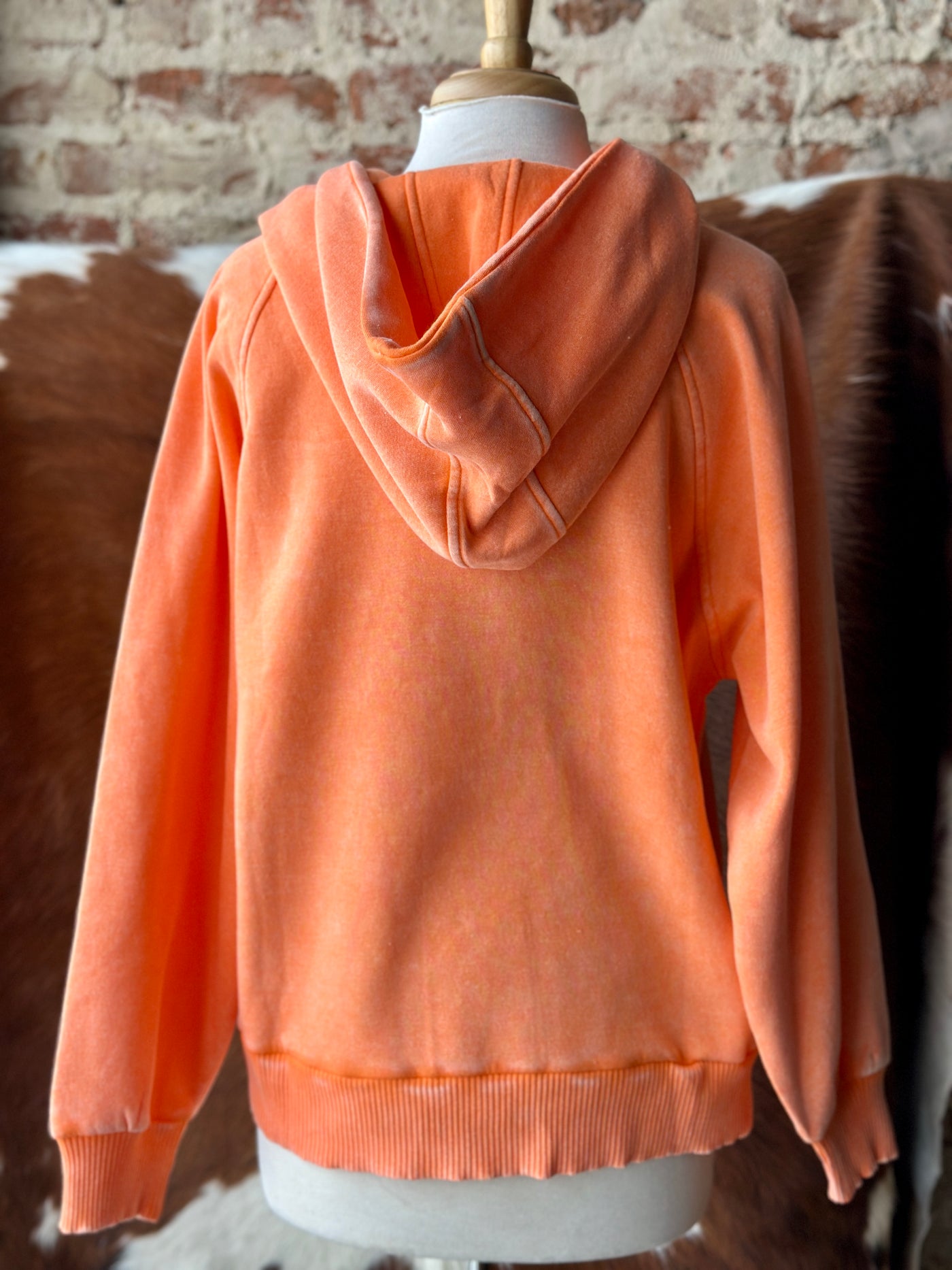 Bright orange mineral-washed quarter-zip pullover hoodie featuring a relaxed fit and soft fleece fabric.