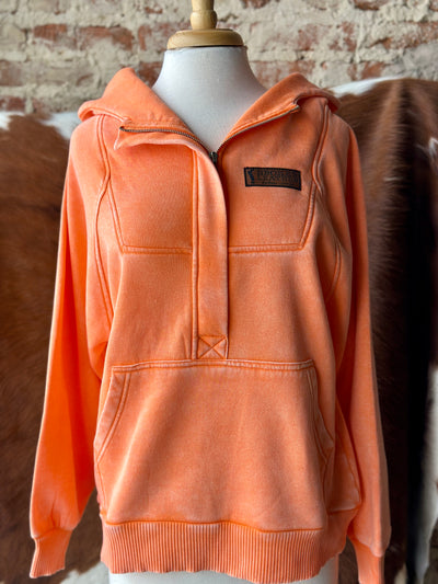 Western-style acid-washed fleece quarter-zip hoodie with kangaroo pocket in bold bright orange.