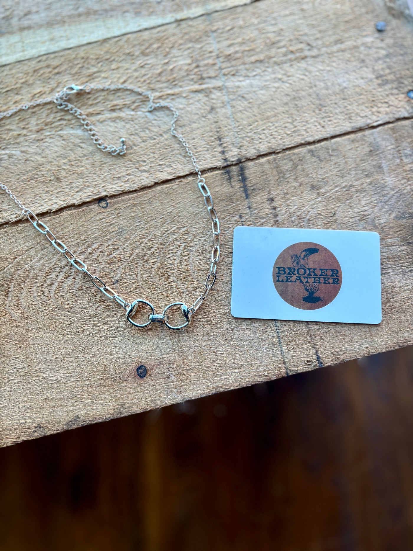 Flat lay comparing sizing on Otis Silver Bit Chain Necklace from Broker Leather.