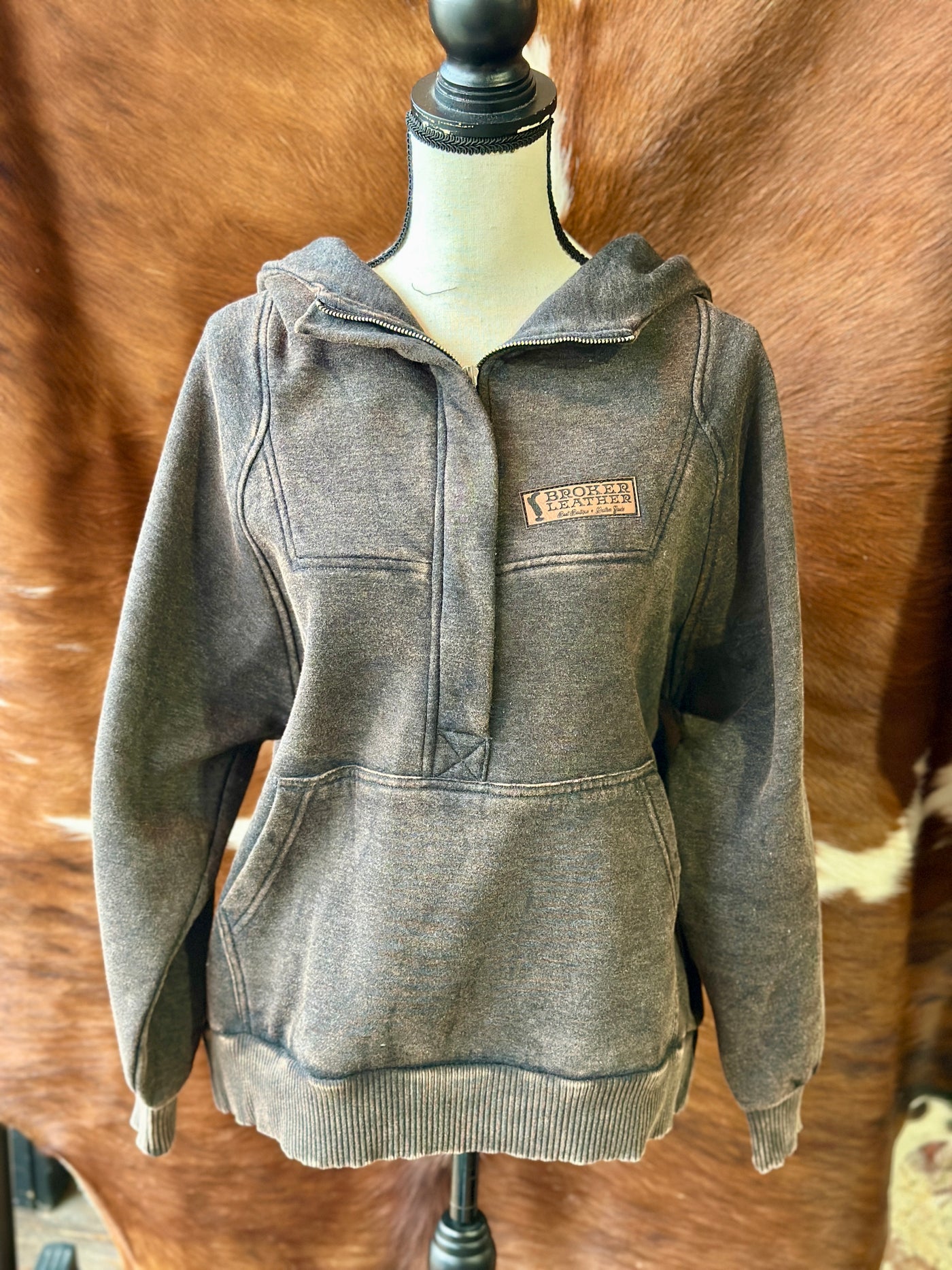 Full view of the Paycheck Quarter Zip Sweatshirt, displayed on a mannequin showcasing the custom Broker Leather patch on the left chest and kangaroo pocket placement.