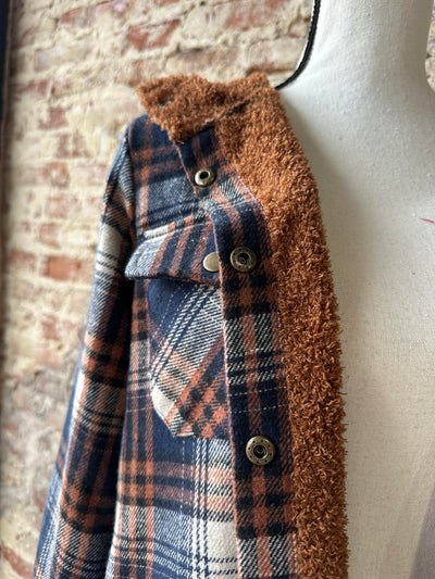 Pinter Plaid Sherpa Lined Shacket displayed on a mannequin, highlighting the fall-inspired plaid colors and cozy lining.