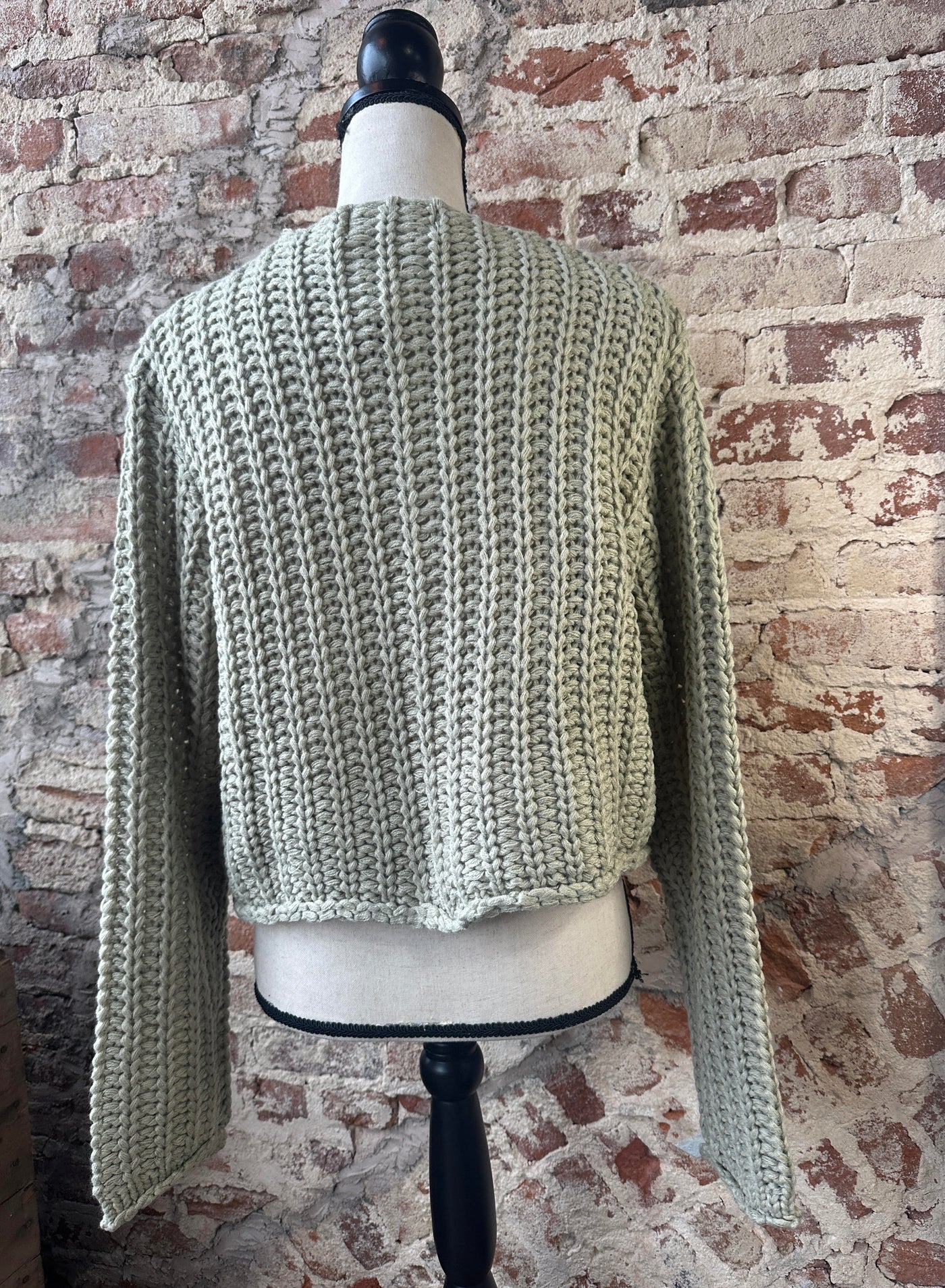 Front view of our Pistachio Chunky Sweater Cardigan on a mannequin.