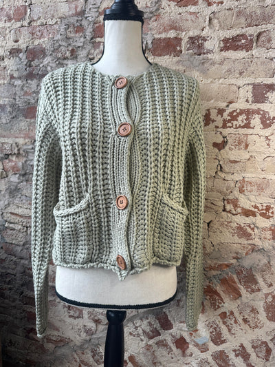 Front view of our Pistachio Chunky Sweater Cardigan on a mannequin.