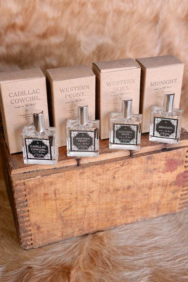 Set of 4 Western perfume sprays, specifically featuring our Cadillac Cowgirl Perfume Spray with kraft box in background.