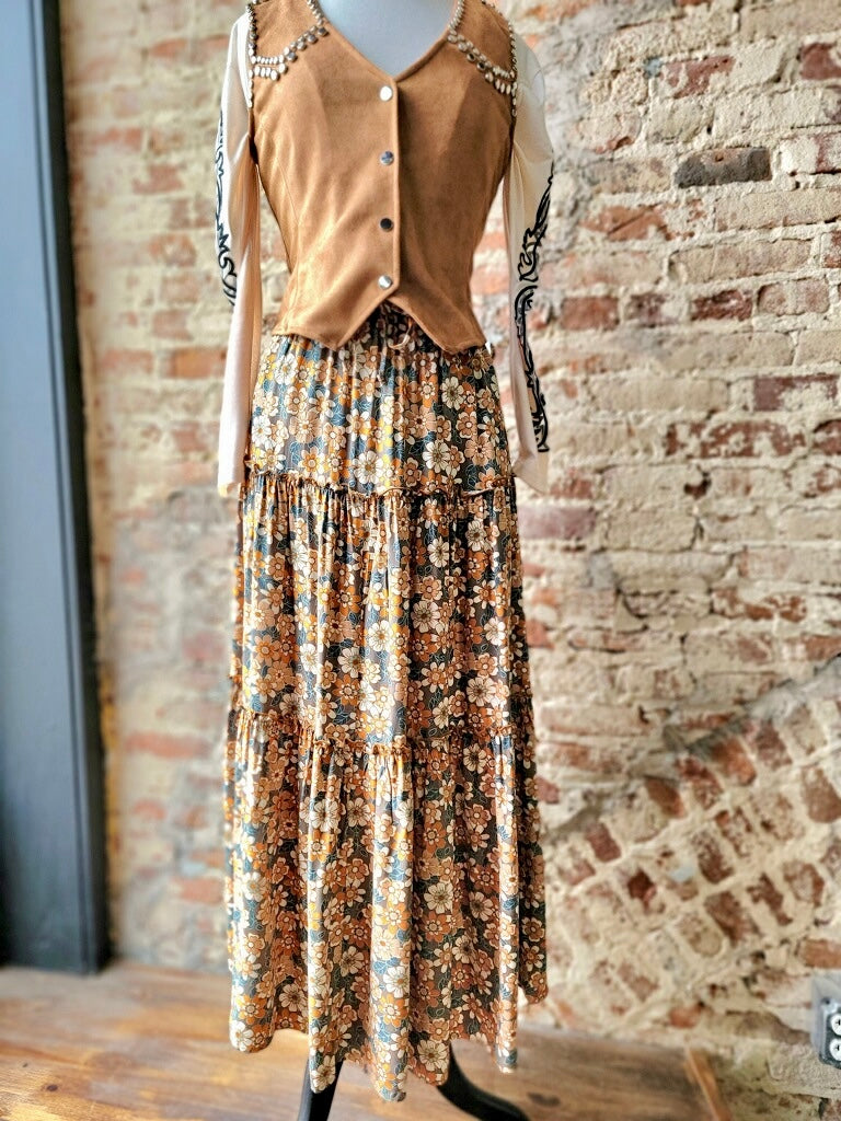 Charming floral print maxi skirt styled with boots for a Western-inspired look.