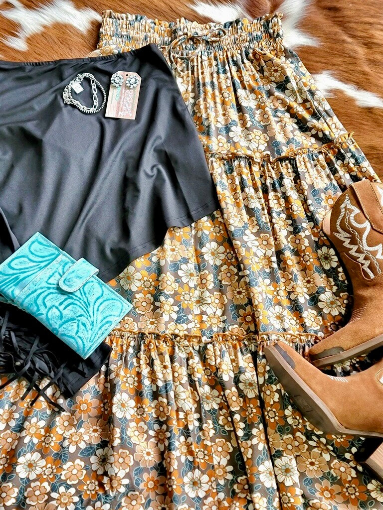 Flat lay outfit at Broker Leather of Raen Dasiy Floral Maxi Skirt that is rodeo ready with accessories. 