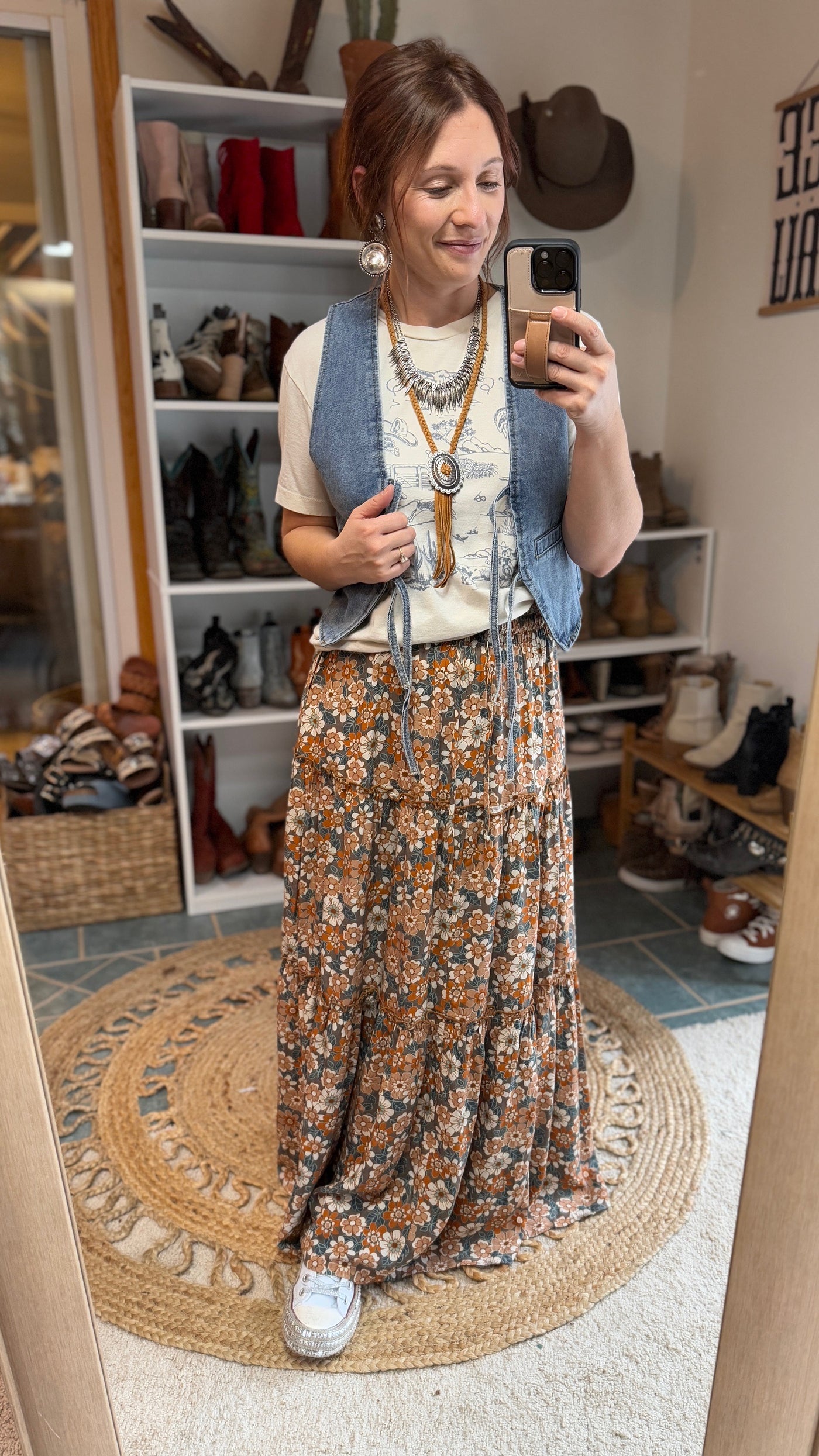 Model from Broker Leather boho-chic Raen Daisy Floral Maxi Skirt with flowing tiers and timeless floral print.