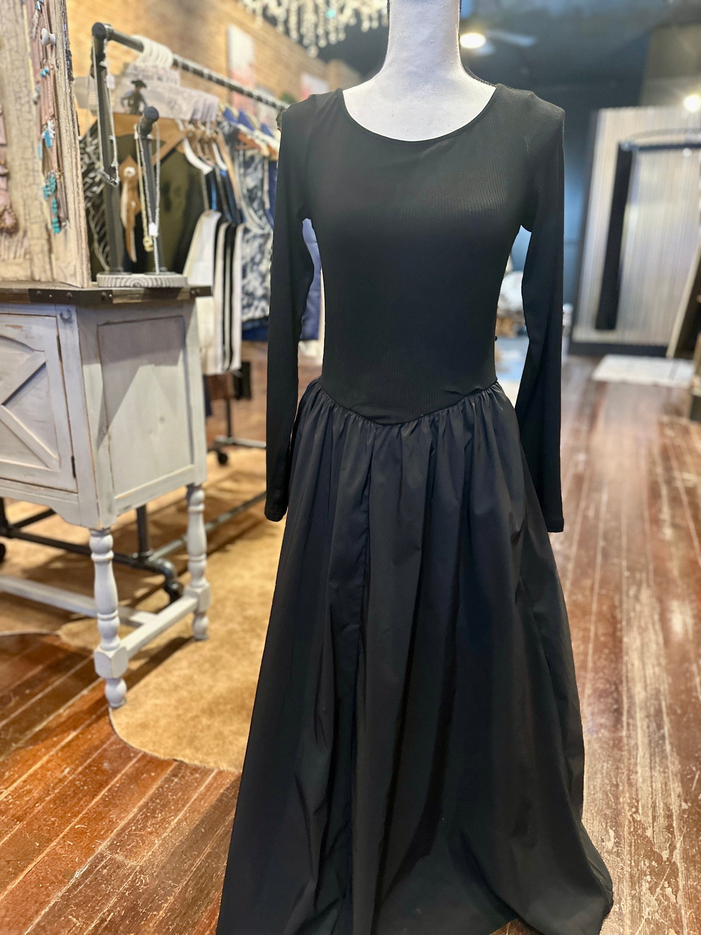 Elegant black boat neck maxi dress with a flattering V-peaked waist.