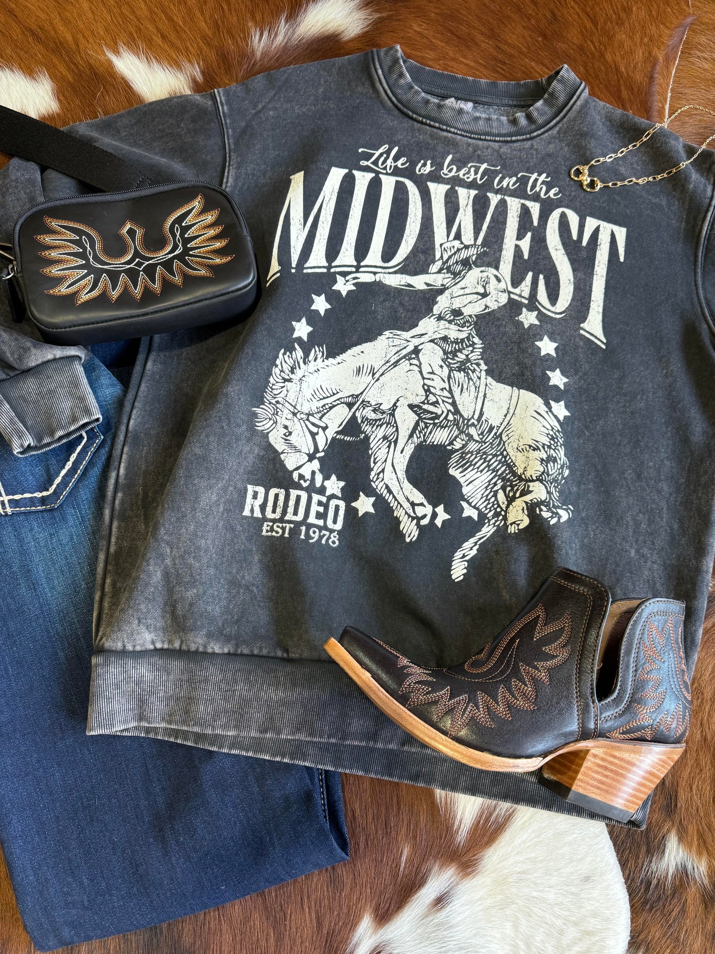 Flatlay outfit featuring our Ria Midwest Rodeo Crewneck [Black & White] and Ariat Dixons.