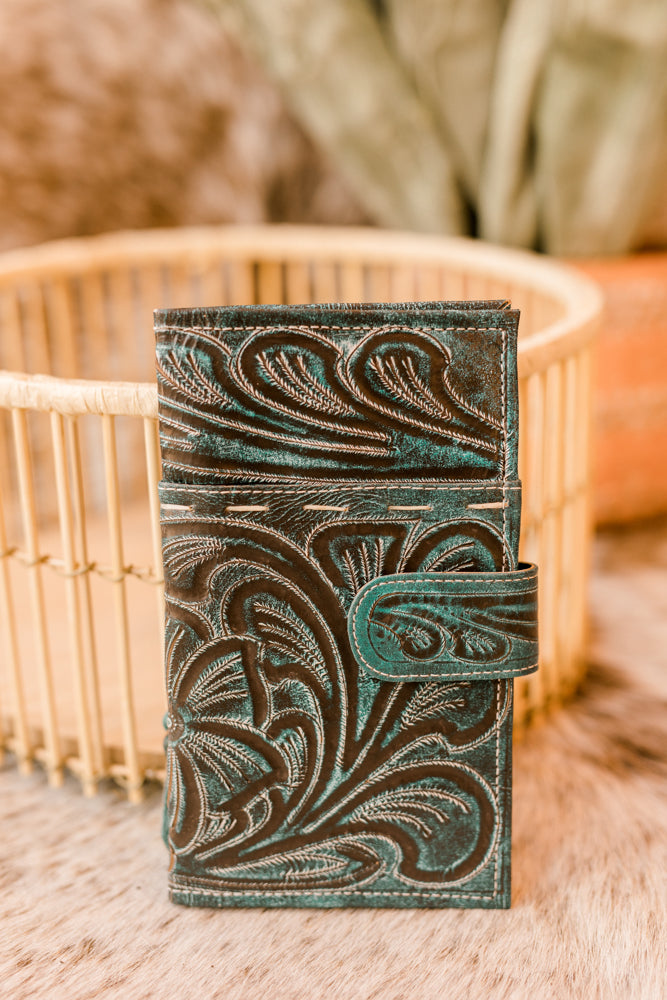 Elevate your everyday essentials with the Ricardo Floral Tooled Wallet [Aqua], a masterpiece from one of our best-selling brands.