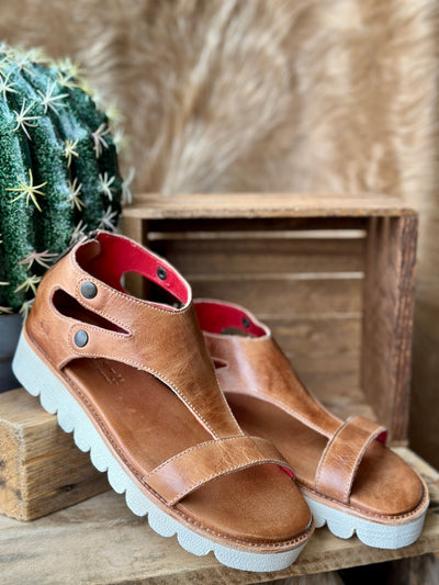 Side view of tan leather platform sandals with 1.5-inch heel and 1-inch sole