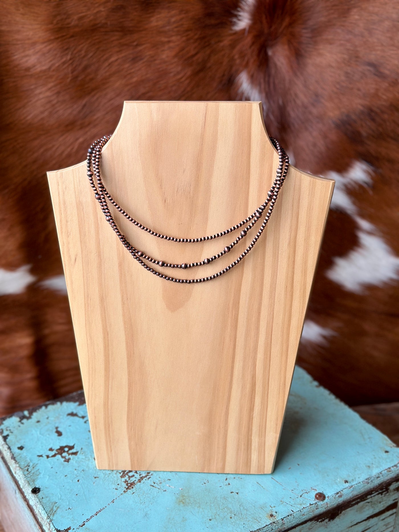 Three-layer copper Navajo bead necklace with 15-inch, 16-inch, and 17-inch strands and a 5-inch extender.