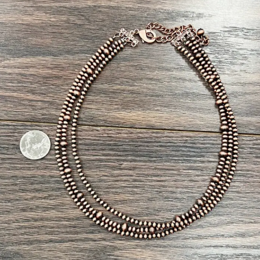 Close-up of the Roger Copper Necklace with a 3-strand design and 4mm, 6mm copper Navajo beads.