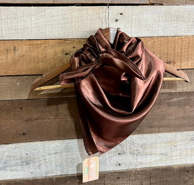 Dark brown wild rag scarf featuring a smooth, luxurious polyester fabric, ideal for rustic cowboy style shown tied on a hanger.