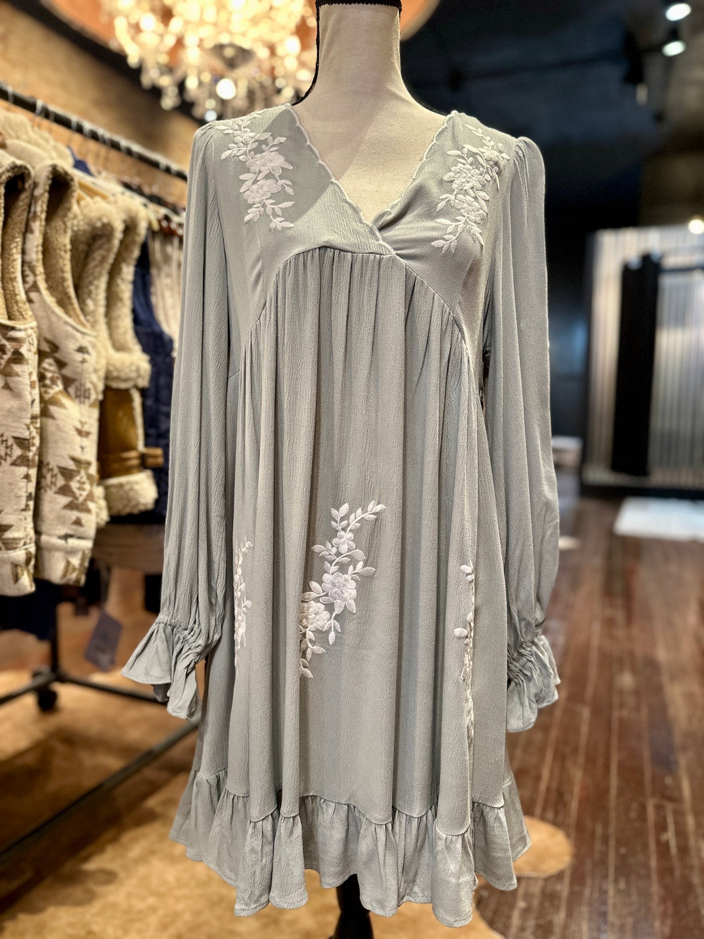 Feminine and flowy dress with delicate ruffle sleeves and hem.