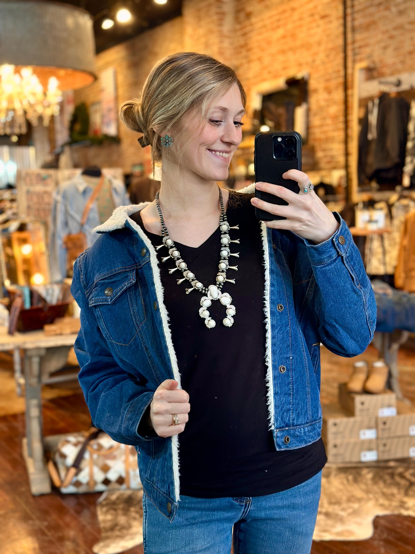 Model wearing the RumChata White Stone Squash Blossom Necklace, paired with a Western-inspired outfit, radiating adventure and style.