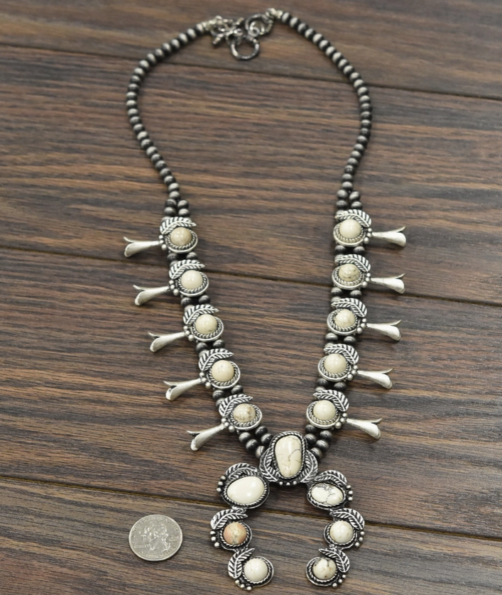 Full view of the RumChata White Stone Squash Blossom Necklace with a 3-inch pendant, perfect for adding a bold touch to any outfit.