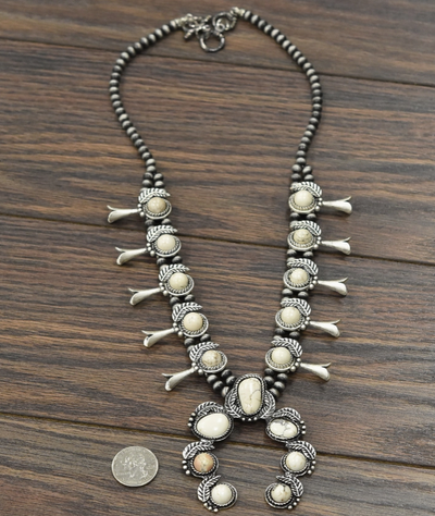 Full view of the RumChata White Stone Squash Blossom Necklace with a 3-inch pendant, perfect for adding a bold touch to any outfit.