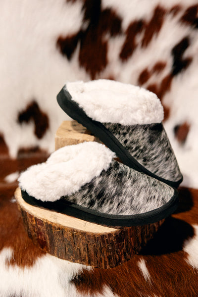 Detailed close-up of Ryggen Genuine Cowhide Slippers showing unique cowhide pattern and plush interior.