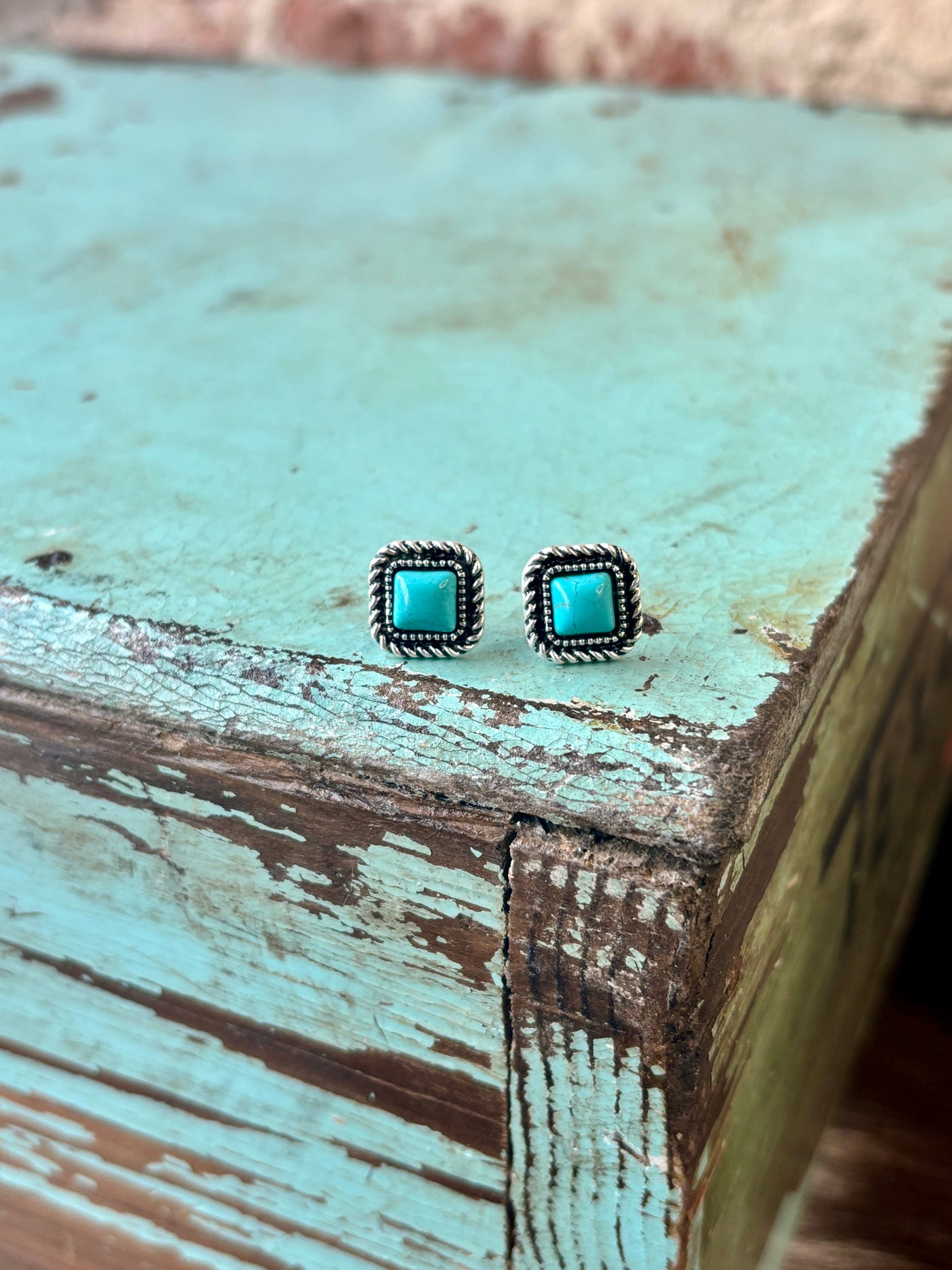 Square turquoise stud earrings with a vintage silver-tone rope border.