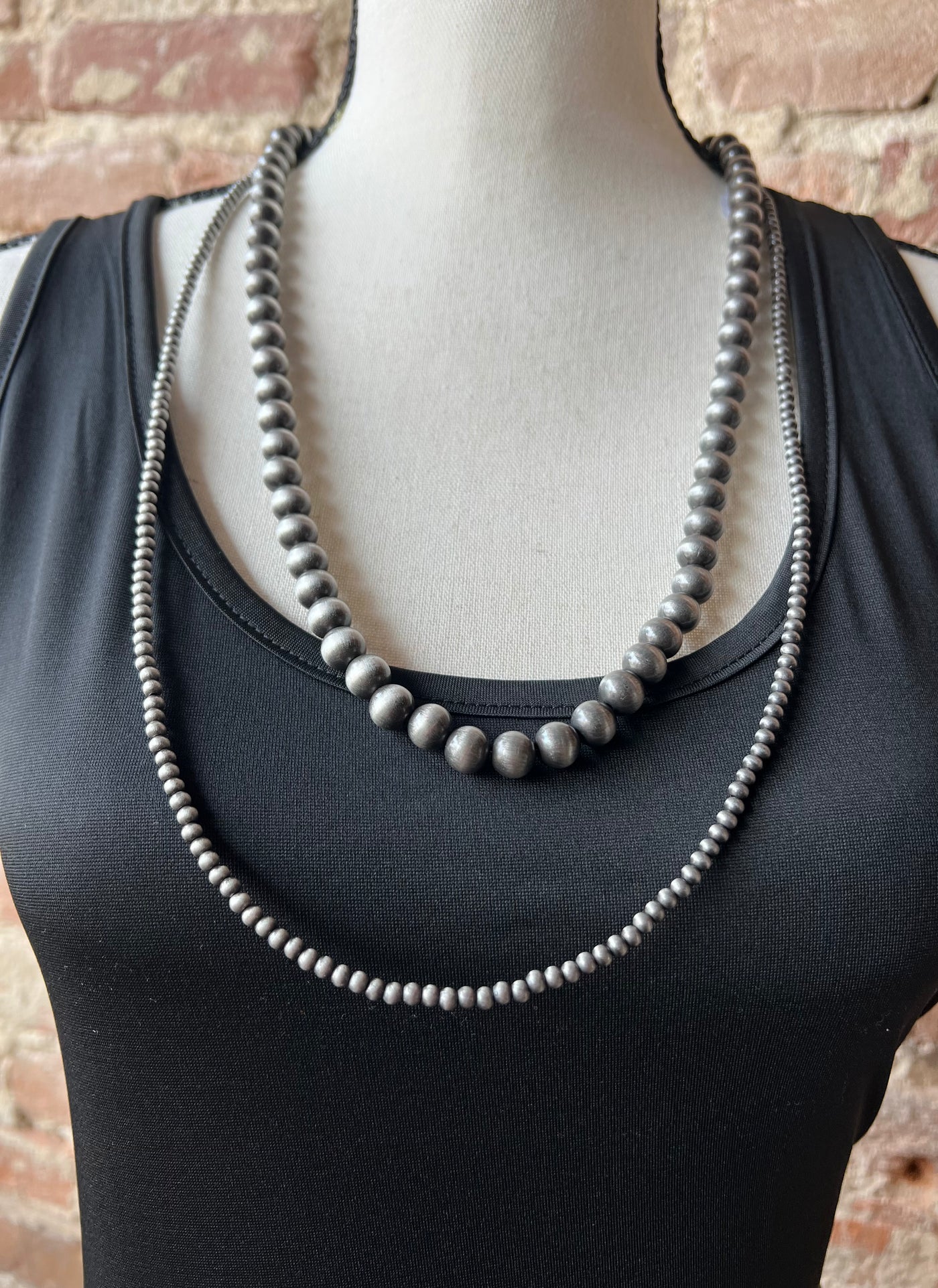 The Sandra 2-Strand Layered Navajo Pearl Necklace displayed on a neutral background, emphasizing its sweet yet spunky style.