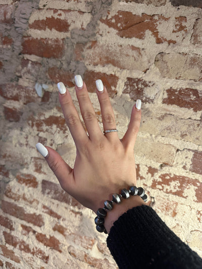 Faux Navajo pearl bracelet displayed on a model from Broker Leather, ready for gift-giving.