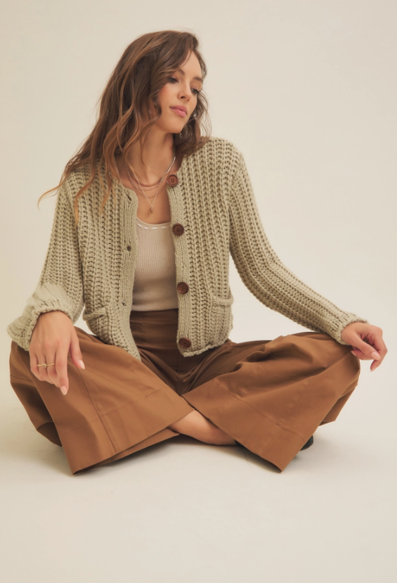 Stock photo of woman modeling our Pistachio Chunky Sweater Cardigan.