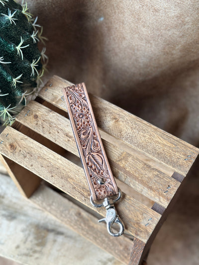 Western tooled leather wristlet keychain with metal clasp and bold rustic detailing