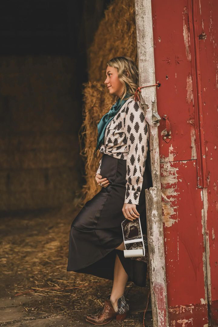 Detailed shot of the intricate black Aztec design on the ivory white fabric of the Sheila top.