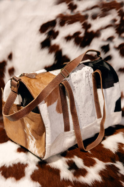 Durable metal feet on the bottom of the Sigmund Cowhide Bag for stability and protection.