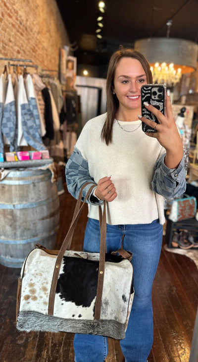 Broker Leather employee modeling our Sigmund Cowhide & Leather Weekender Bag.