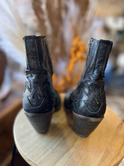 Close-up of Liberty Black Booties showcasing leather texture and worn-in charm.