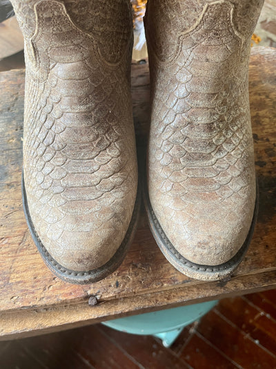 Overhead shot of the gently worn snake print boots showcasing their round toe shape.